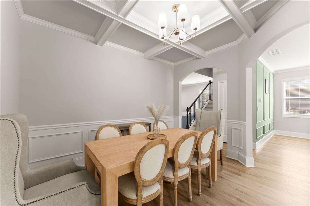 6667 Rivergreen Road Flowery Branch, GA 30542 - Photo 13 of 50 a view of a dining room with furniture and wooden floor