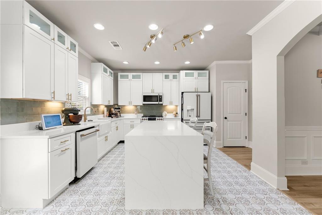 6667 Rivergreen Road Flowery Branch, GA 30542 - Photo 16 of 50 a large white kitchen with lots of counter space wooden cabinets and stainless steel appliances