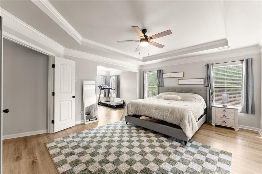 6667 Rivergreen Road Flowery Branch, GA 30542 - Photo 20 of 50 a bedroom with a large bed and a window