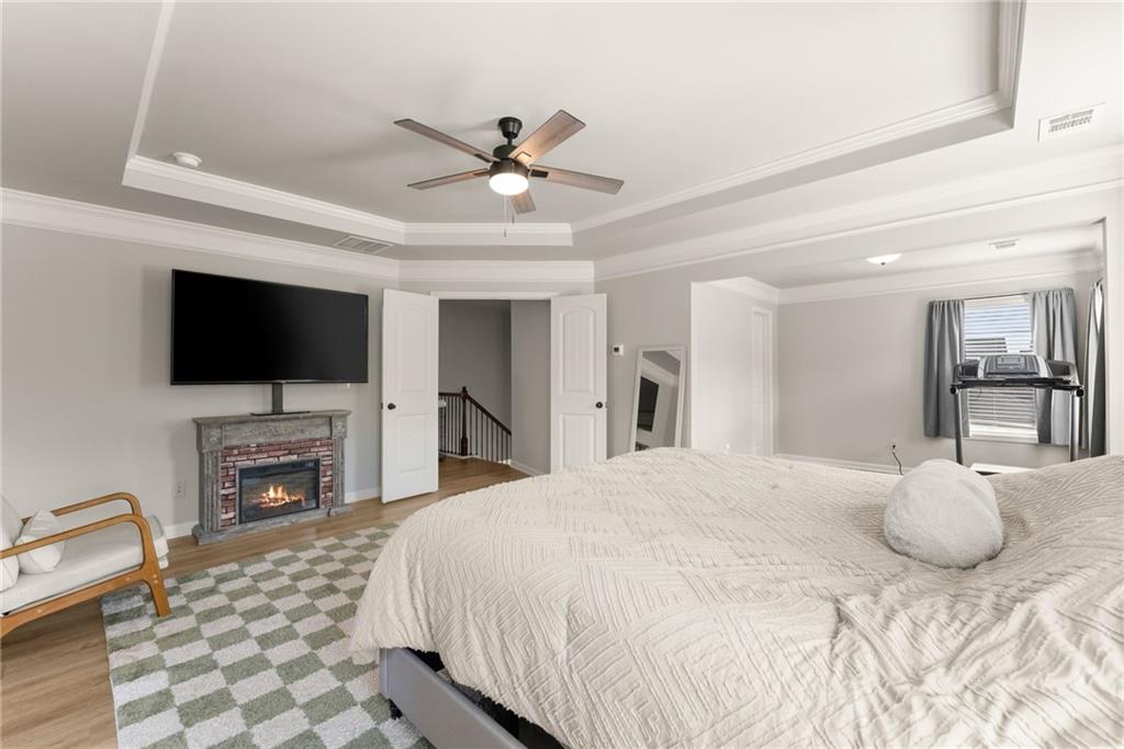 6667 Rivergreen Road Flowery Branch, GA 30542 - Photo 21 of 50 a bedroom with a bed and a flat screen tv