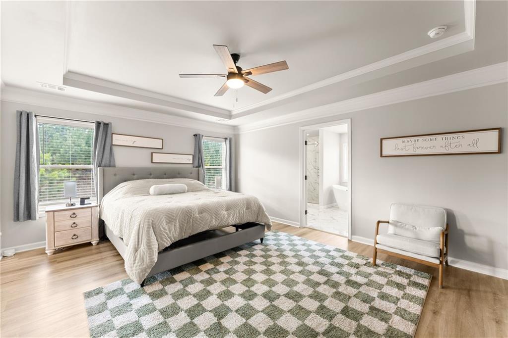 6667 Rivergreen Road Flowery Branch, GA 30542 - Photo 22 of 50 a bedroom with a large bed and a window