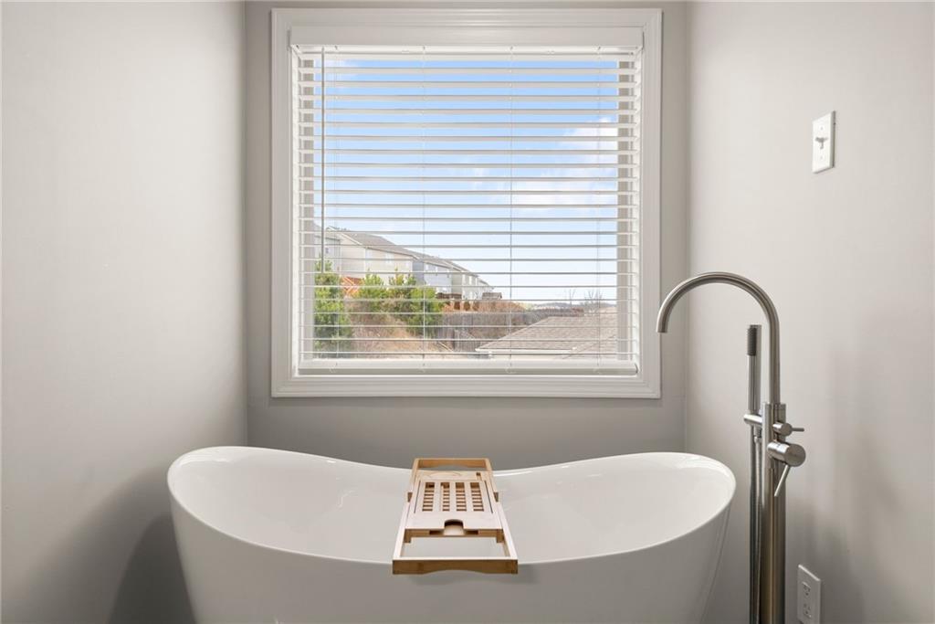 6667 Rivergreen Road Flowery Branch, GA 30542 - Photo 28 of 50 a bathroom with a tub and a sink