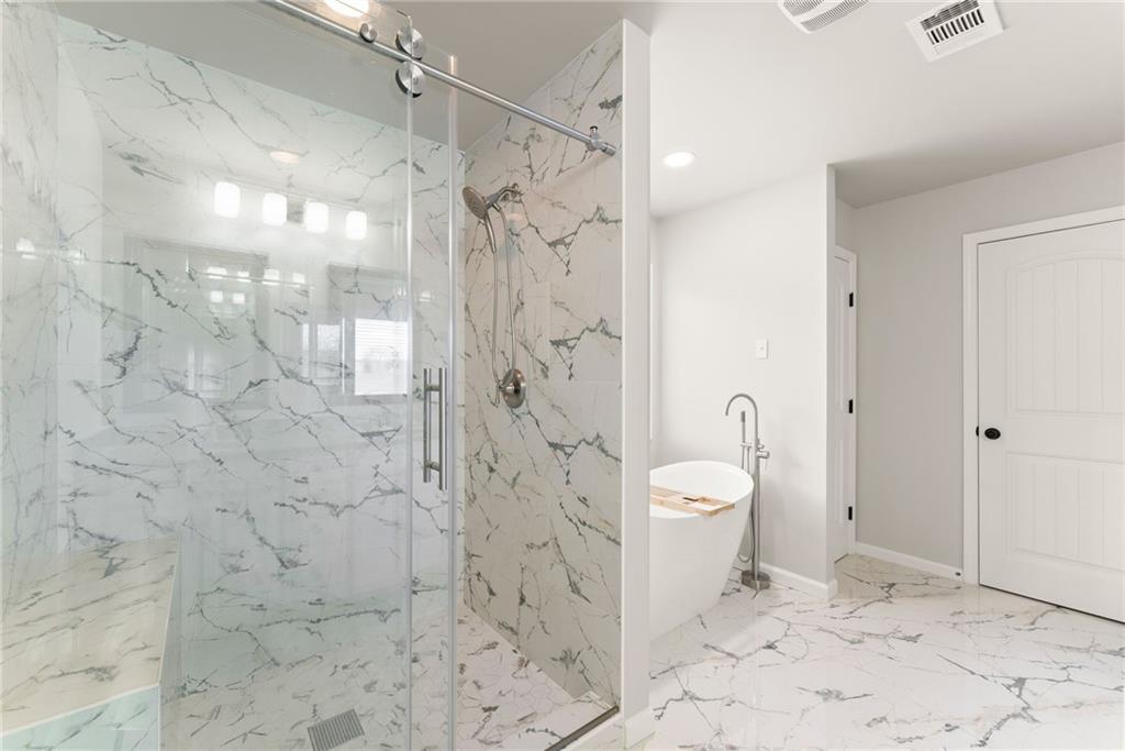 6667 Rivergreen Road Flowery Branch, GA 30542 - Photo 29 of 50 a bathroom with a granite countertop shower a toilet and a shower