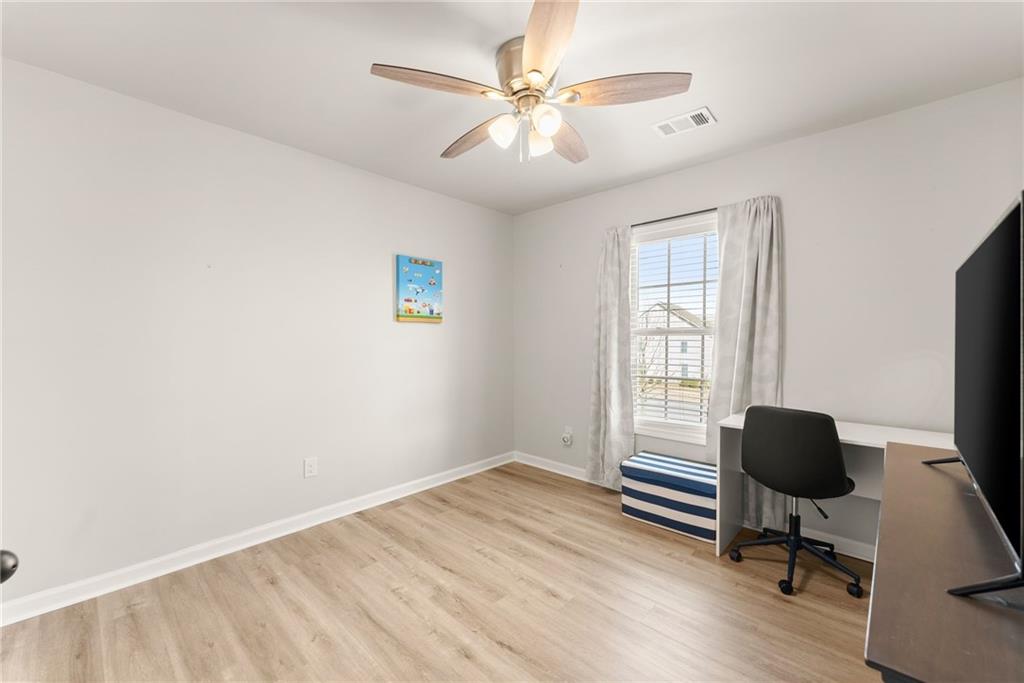 6667 Rivergreen Road Flowery Branch, GA 30542 - Photo 30 of 50 a workspace with wooden floor and a window