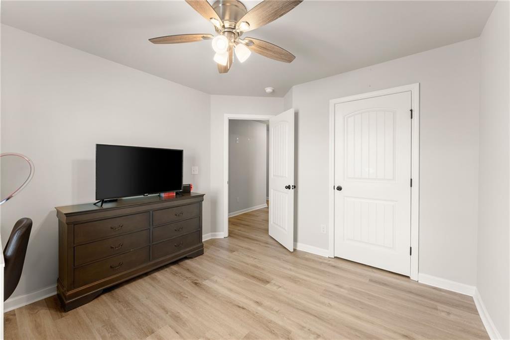 6667 Rivergreen Road Flowery Branch, GA 30542 - Photo 31 of 50 a living room with furniture and a flat screen tv
