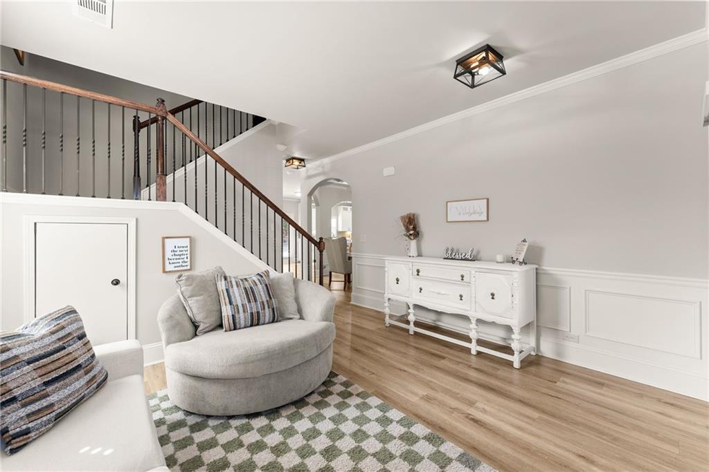 6667 Rivergreen Road Flowery Branch, GA 30542 - Photo 6 of 50 a living room with furniture and a baby crib