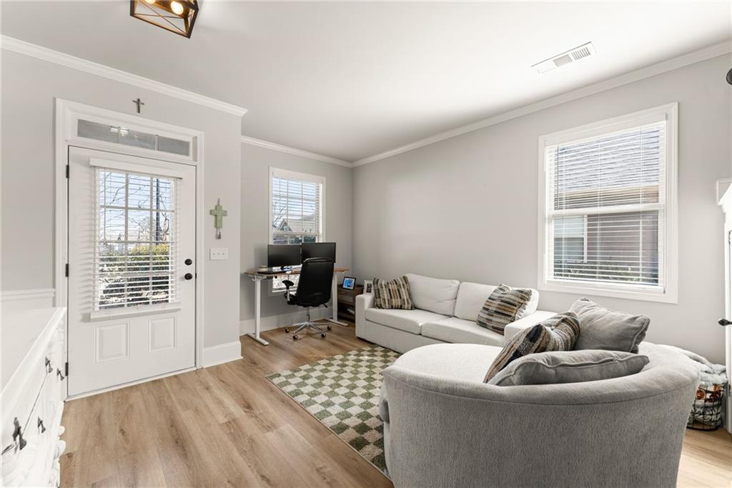 6667 Rivergreen Road Flowery Branch, GA 30542 - Photo 7 of 50 a living room with furniture and a window