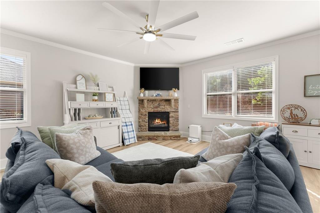 6667 Rivergreen Road Flowery Branch, GA 30542 - Photo 8 of 50 a living room with furniture window and a fireplace