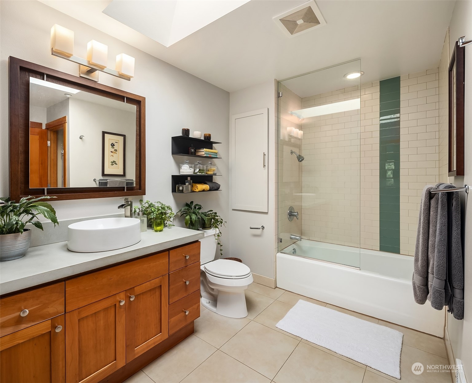 1605 East Pike Street, Unit 201 Seattle, WA 98122 - Photo 13 of 20 a bathroom with a double vanity sink toilet and shower
