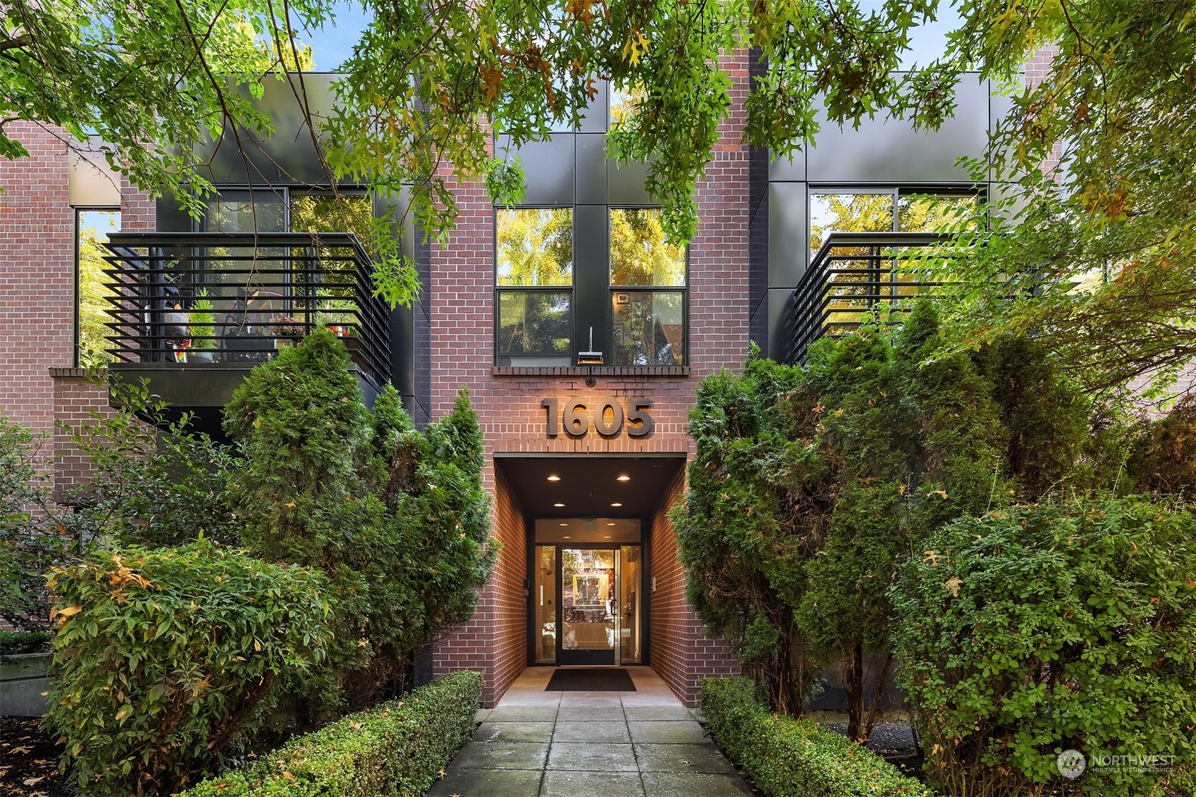 1605 East Pike Street, Unit 201 Seattle, WA 98122 - Photo 2 of 20 a front view of a house with a yard