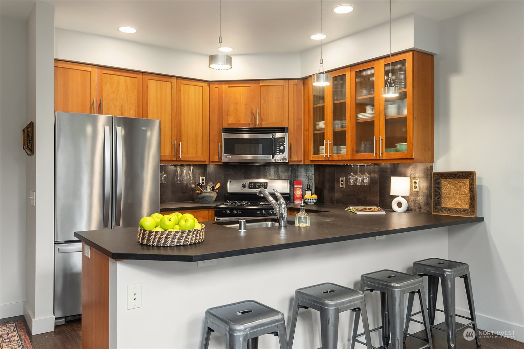 1605 East Pike Street, Unit 201 Seattle, WA 98122 - Photo 7 of 20 a kitchen with stainless steel appliances granite countertop a refrigerator and a stove top oven
