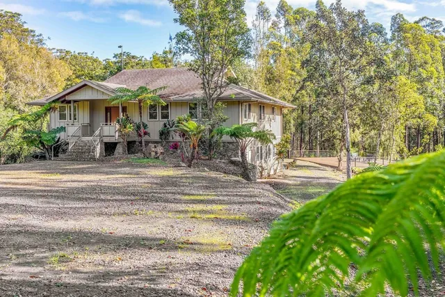 a front view of a house with a yard table and chairs