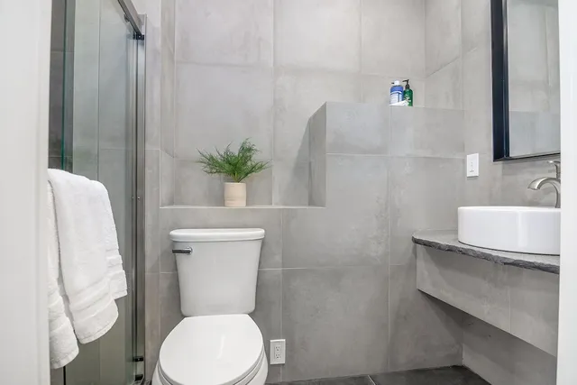 a white toilet sitting next to a bathroom sink