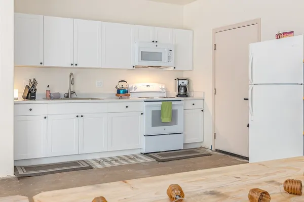 a kitchen with cabinets and appliances