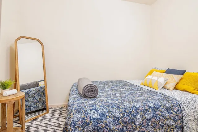 a bedroom with a bed and a couch