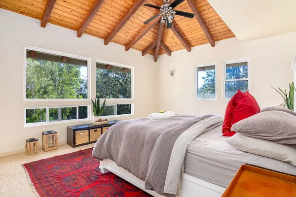 a bedroom with a bed cabinets and a window