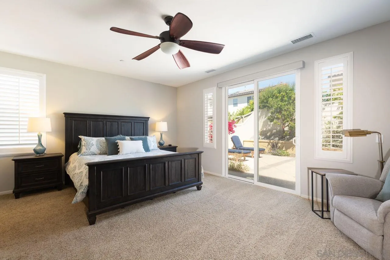 17662 Ralphs Ranch Road San Diego, CA 92127 - Photo 13 of 27 a bed sitting in a spacious bedroom next to a window