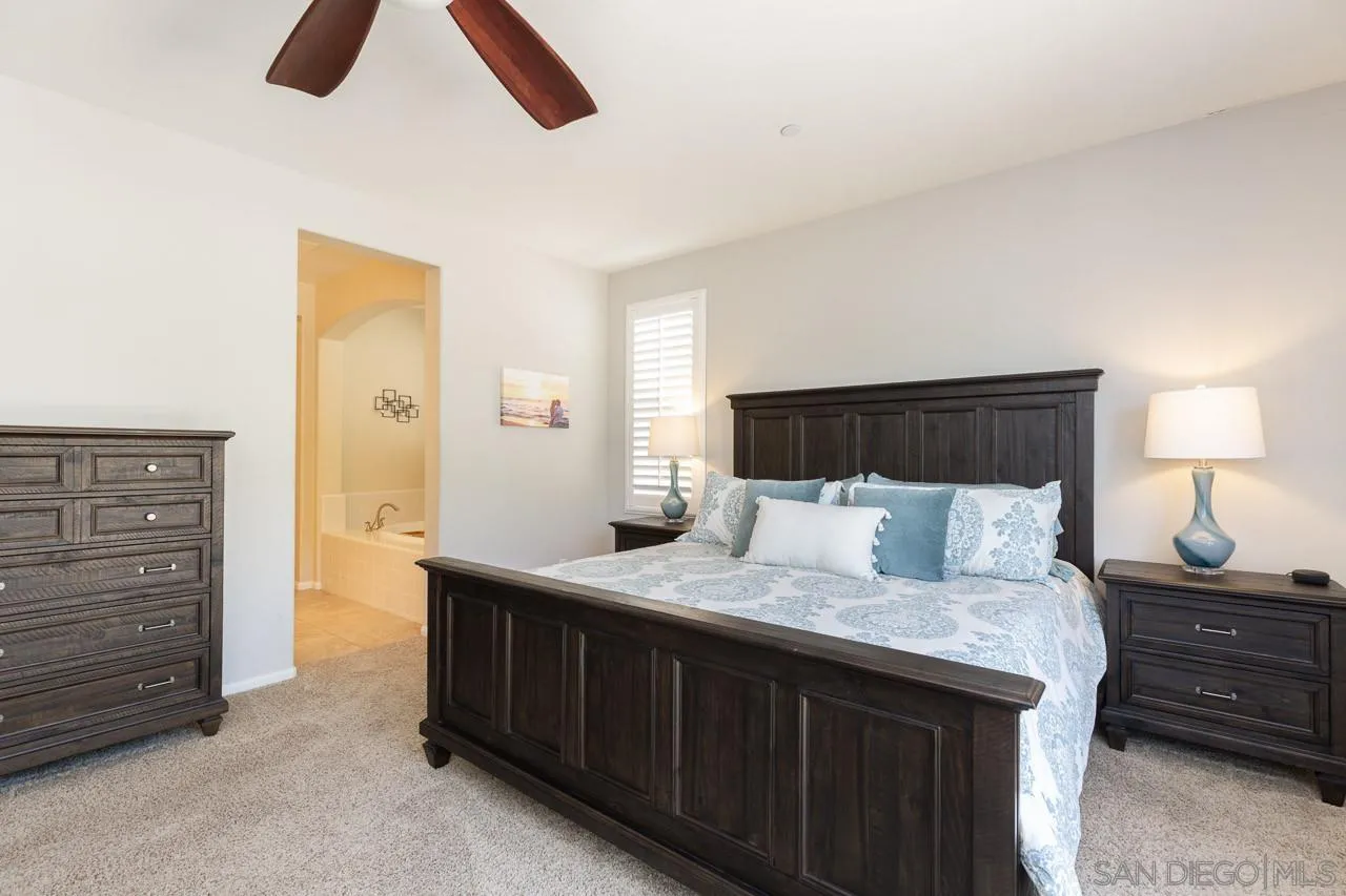 17662 Ralphs Ranch Road San Diego, CA 92127 - Photo 14 of 27 a bedroom with a bed and a night stand