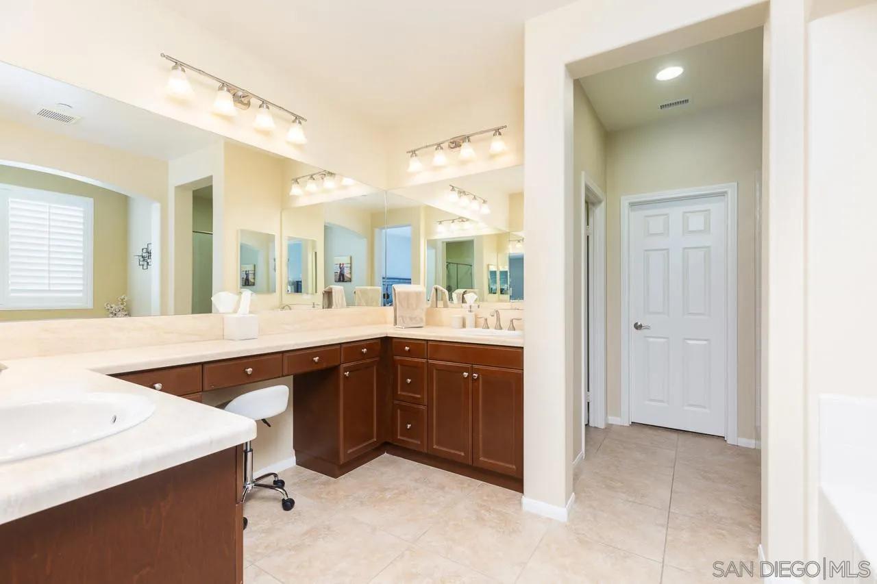 17662 Ralphs Ranch Road San Diego, CA 92127 - Photo 15 of 27 a spacious bathroom with a sink vanity and a mirror