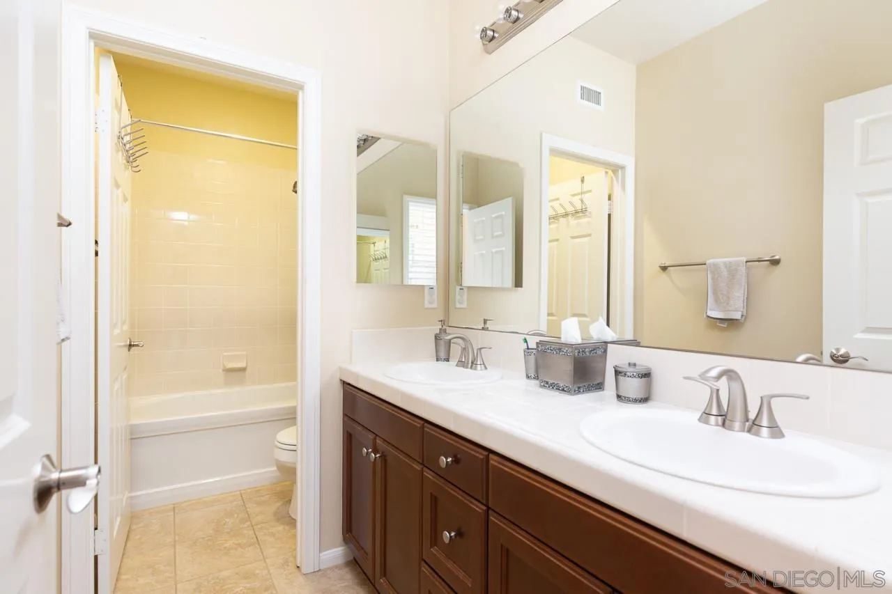 17662 Ralphs Ranch Road San Diego, CA 92127 - Photo 20 of 27 a bathroom with a tub a sink and a mirror