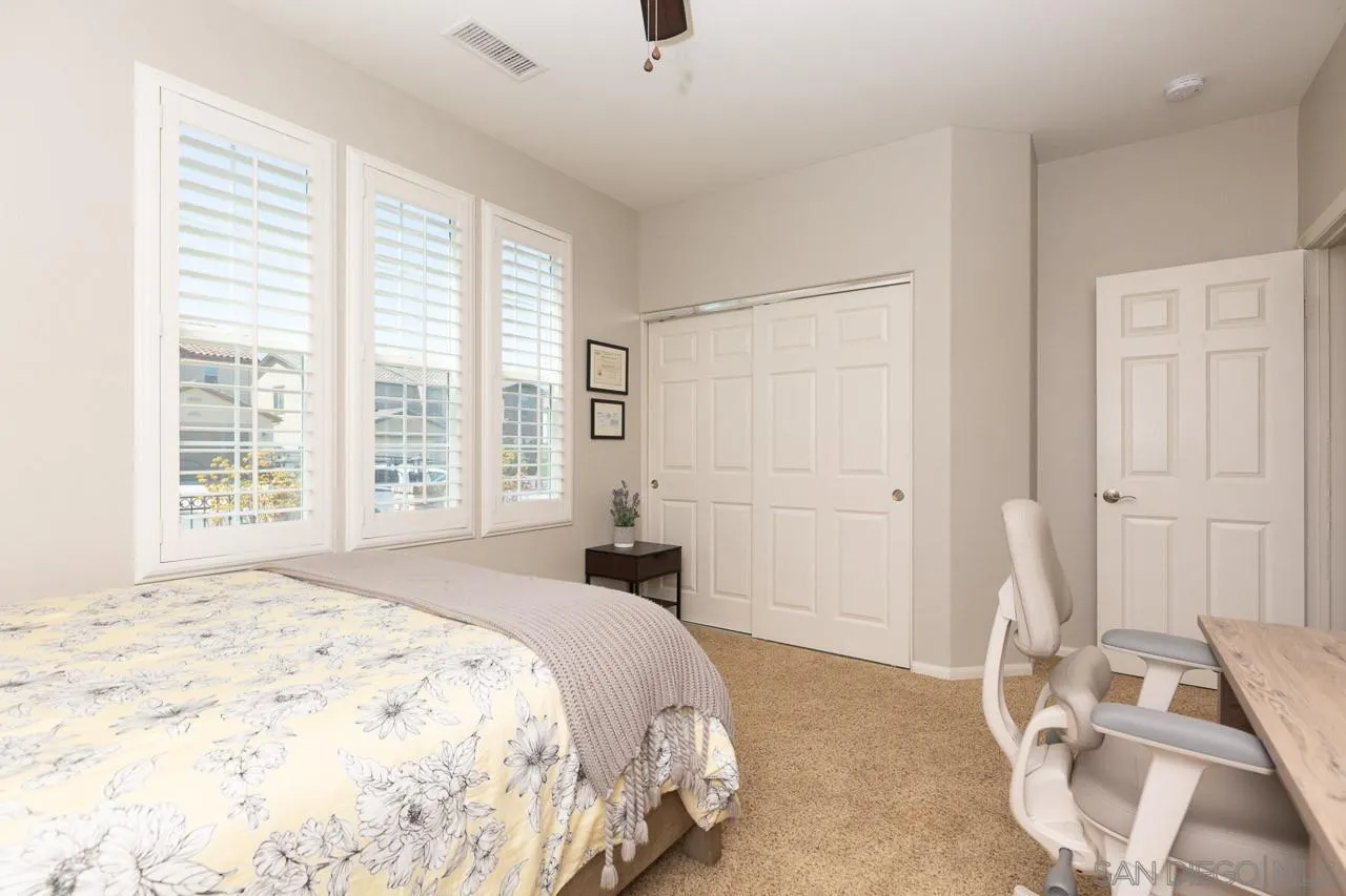 17662 Ralphs Ranch Road San Diego, CA 92127 - Photo 22 of 27 a bedroom with a bed and a window