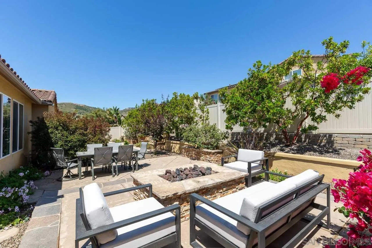 17662 Ralphs Ranch Road San Diego, CA 92127 - Photo 23 of 27 a view of a patio with couches and table and chairs and potted plants