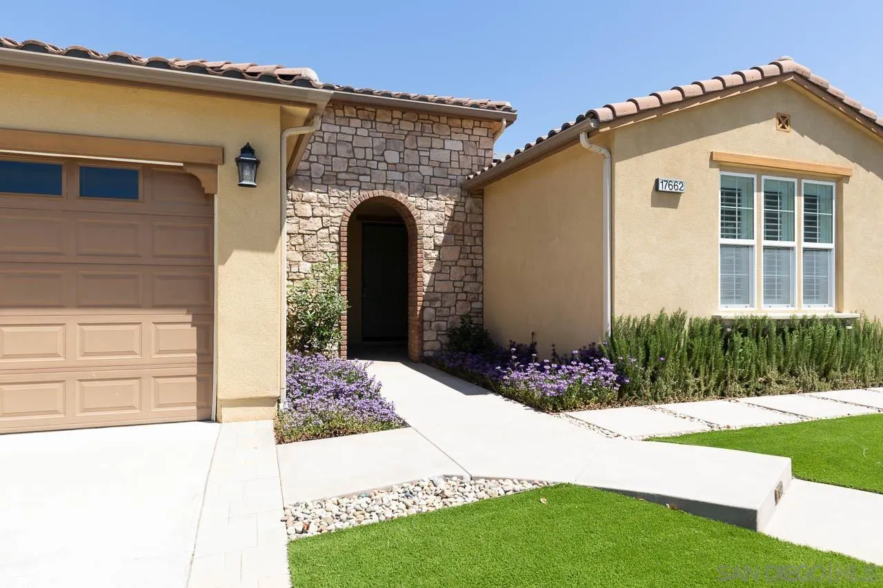 17662 Ralphs Ranch Road San Diego, CA 92127 - Photo 3 of 27 a front view of a house with garden