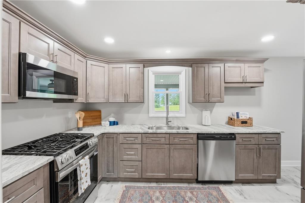 17 Shenango Road New Castle, PA 16105 - Photo 6 of 16 a kitchen with stainless steel appliances granite countertop a sink stove and microwave