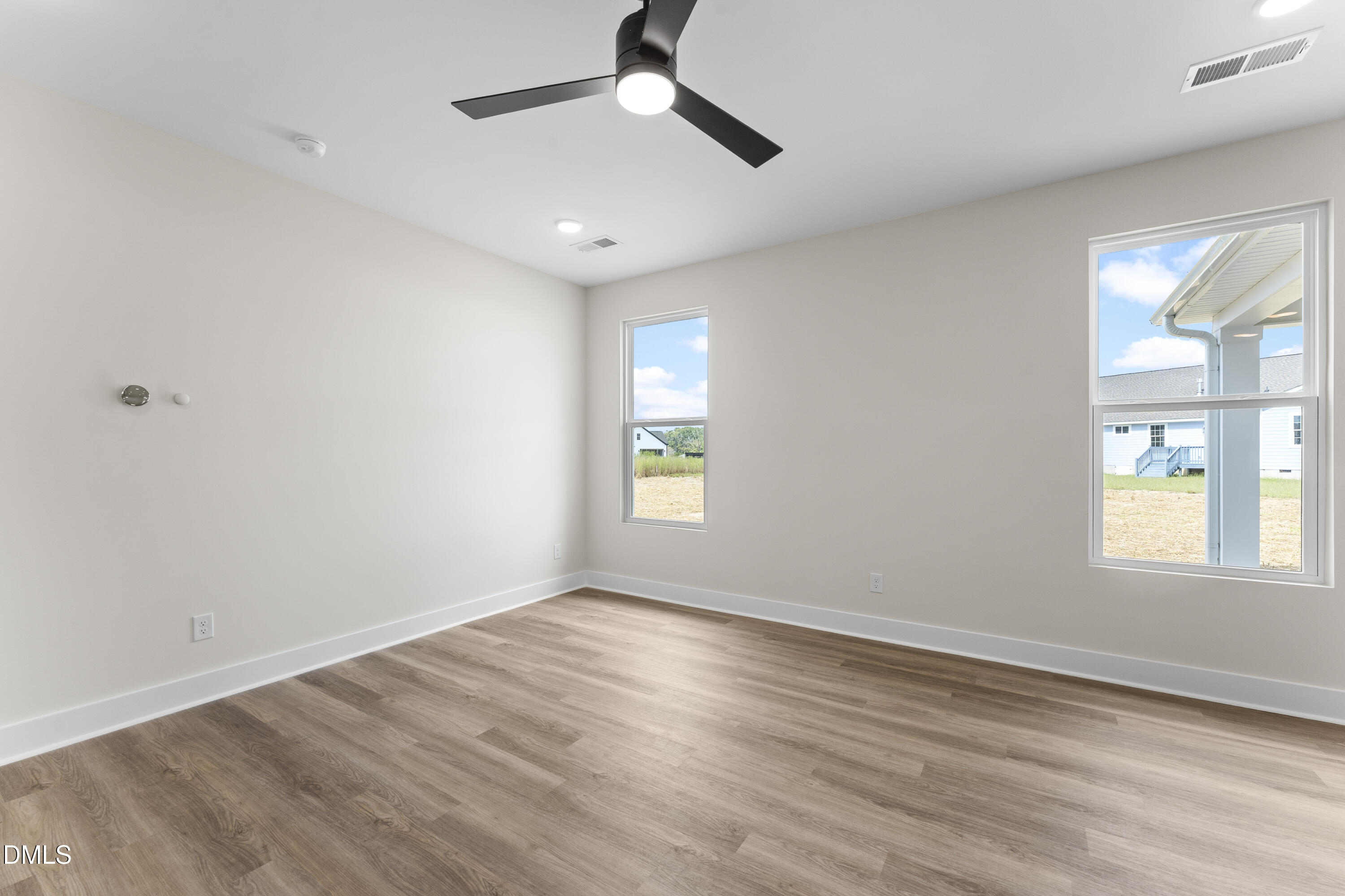 7628 New Sandy Hill Church Road Sims, NC 27880 - Photo 10 of 46 a view of an empty room with wooden floor and a window