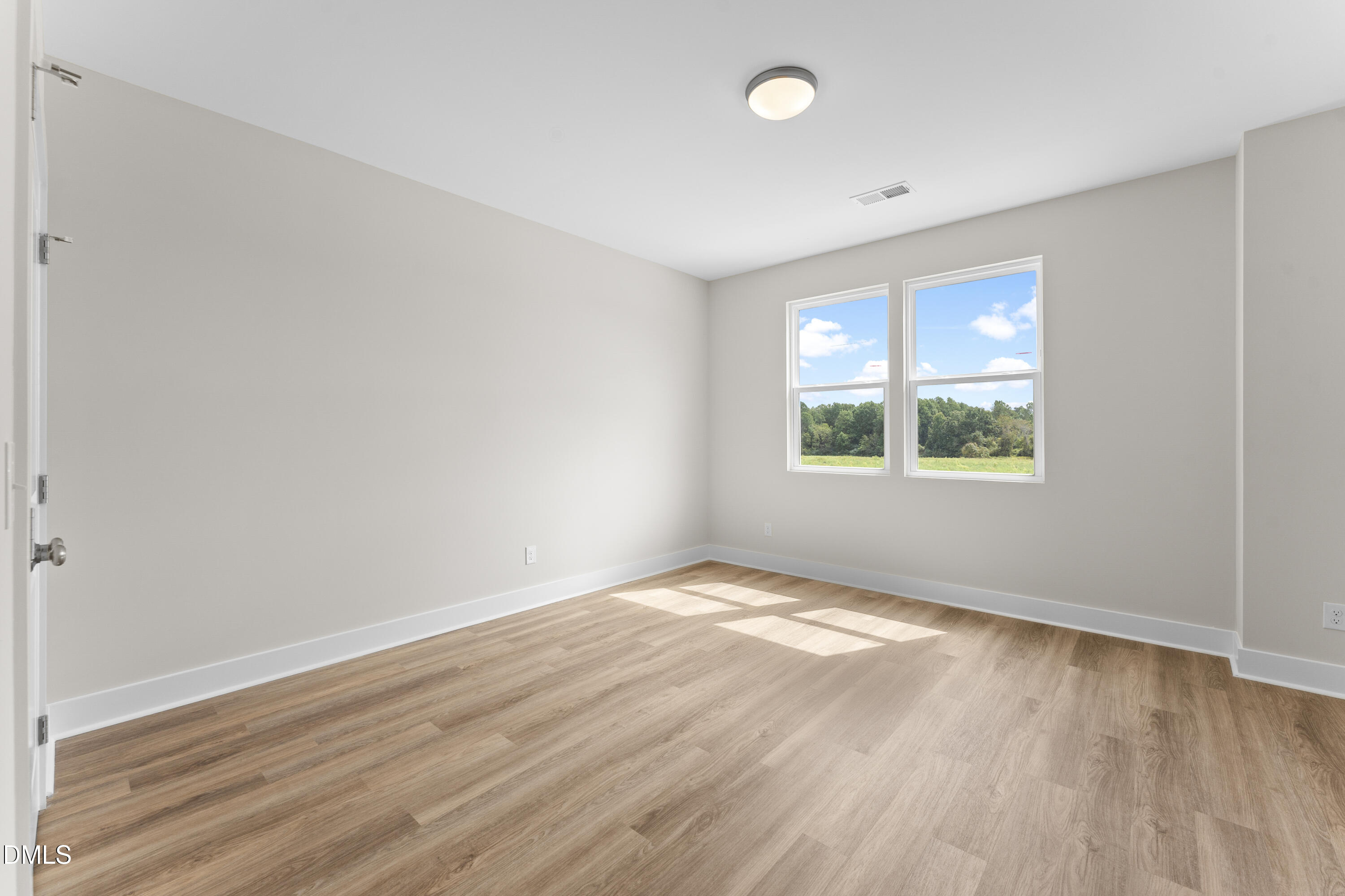 7628 New Sandy Hill Church Road Sims, NC 27880 - Photo 29 of 46 an empty room with wooden floor and windows