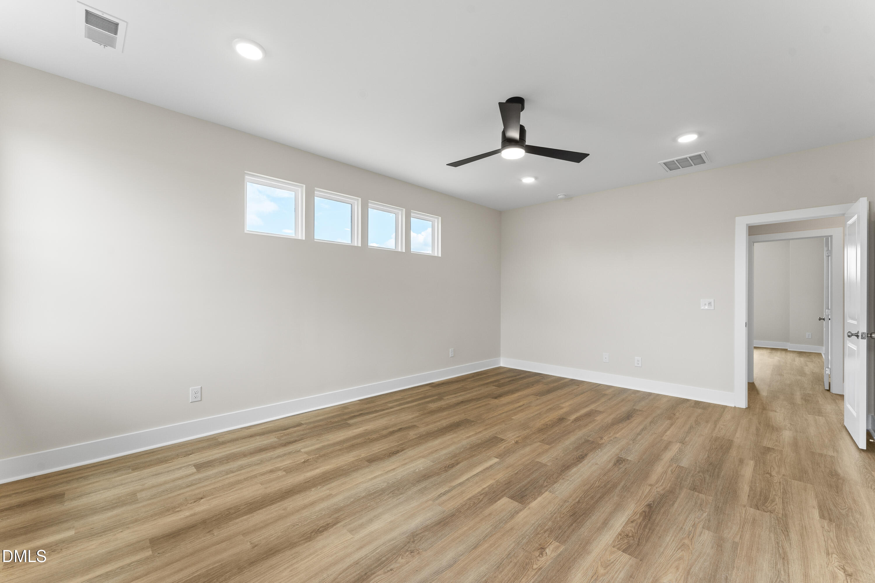 7628 New Sandy Hill Church Road Sims, NC 27880 - Photo 35 of 46 a view of an empty room with wooden floor and a ceiling fan