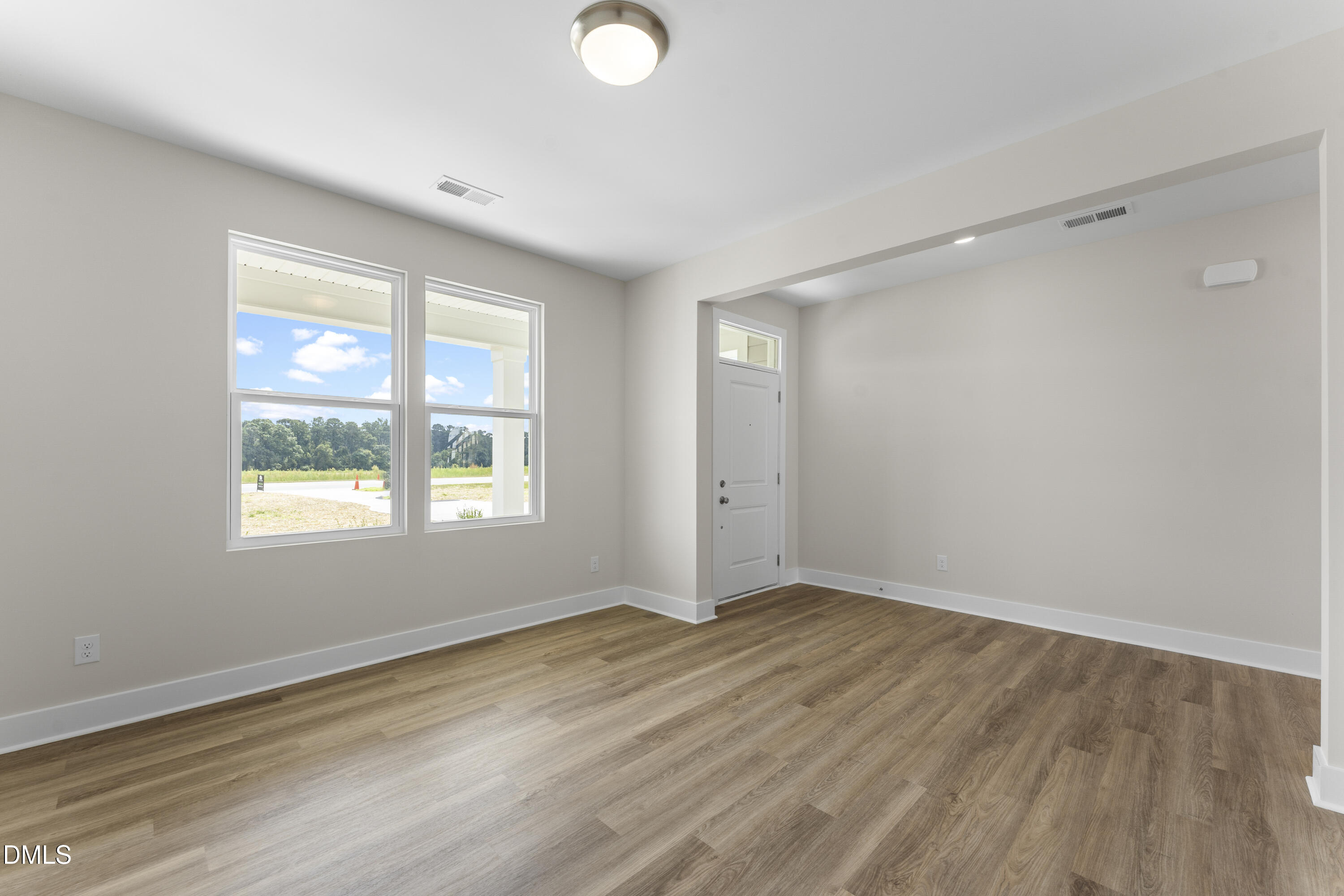 7628 New Sandy Hill Church Road Sims, NC 27880 - Photo 8 of 46 a view of an empty room with wooden floor and a window