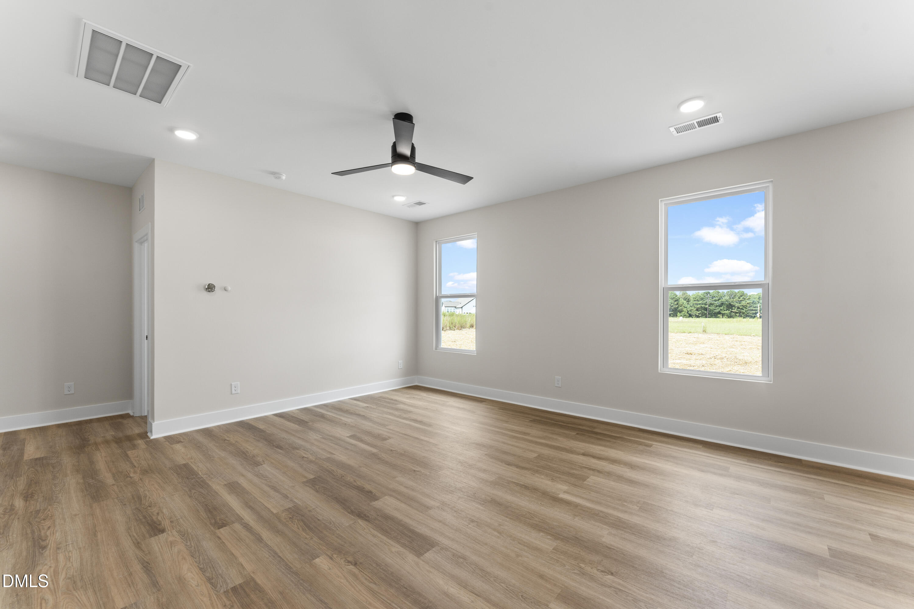 7628 New Sandy Hill Church Road Sims, NC 27880 - Photo 9 of 46 a view of an empty room with window and wooden floor