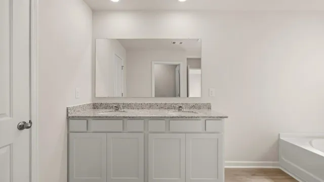 a view of an empty room with closet and a window