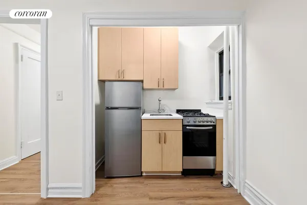 a kitchen with a refrigerator sink stove and cabinets