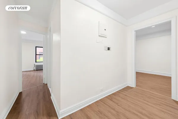 a view of a hallway with wooden floor