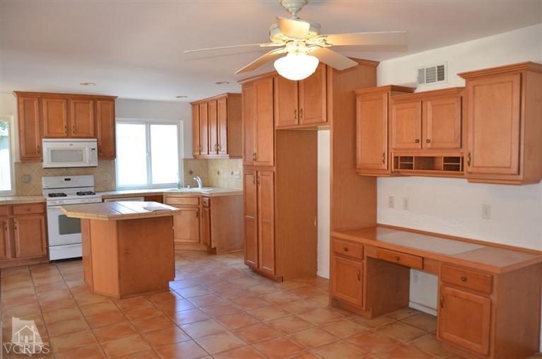 5776 Katherine Street Simi Valley, CA 93063 - Photo 1 of 11 a kitchen with stainless steel appliances a sink a stove a refrigerator cabinets and a window