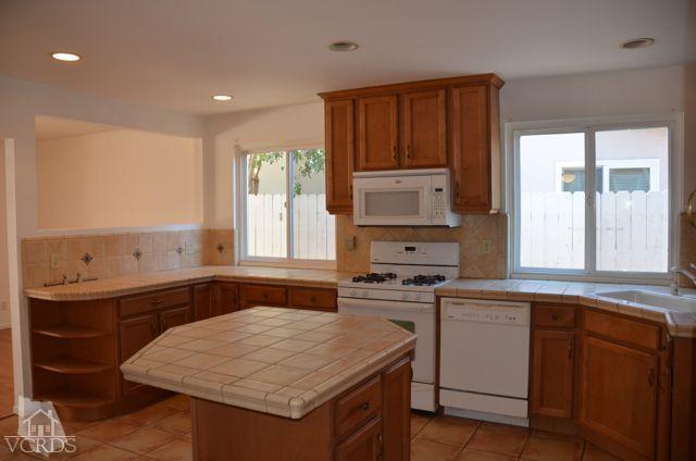 5776 Katherine Street Simi Valley, CA 93063 - Photo 2 of 11 a kitchen with a sink stove and microwave
