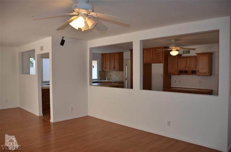 5776 Katherine Street Simi Valley, CA 93063 - Photo 5 of 11 a view of a hallway with wooden floor and a dining room