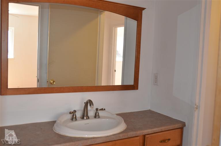 5776 Katherine Street Simi Valley, CA 93063 - Photo 7 of 11 a bathroom with a sink and a mirror