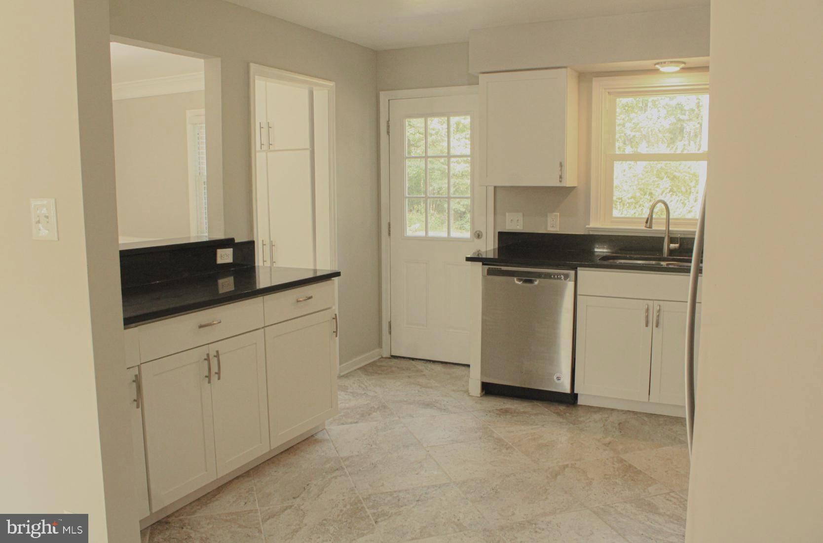 25073 Oxford Road Ruther Glen, VA 22546 - Photo 13 of 37 a kitchen with stainless steel appliances granite countertop a stove a sink and a refrigerator
