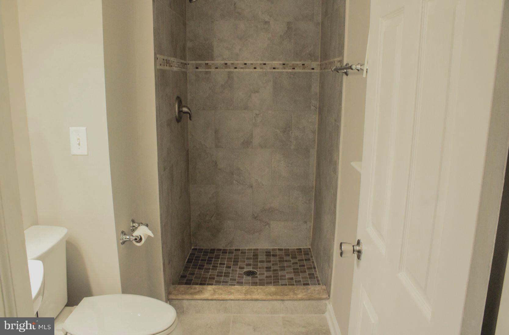 25073 Oxford Road Ruther Glen, VA 22546 - Photo 21 of 37 a bathroom with a shower and toilet