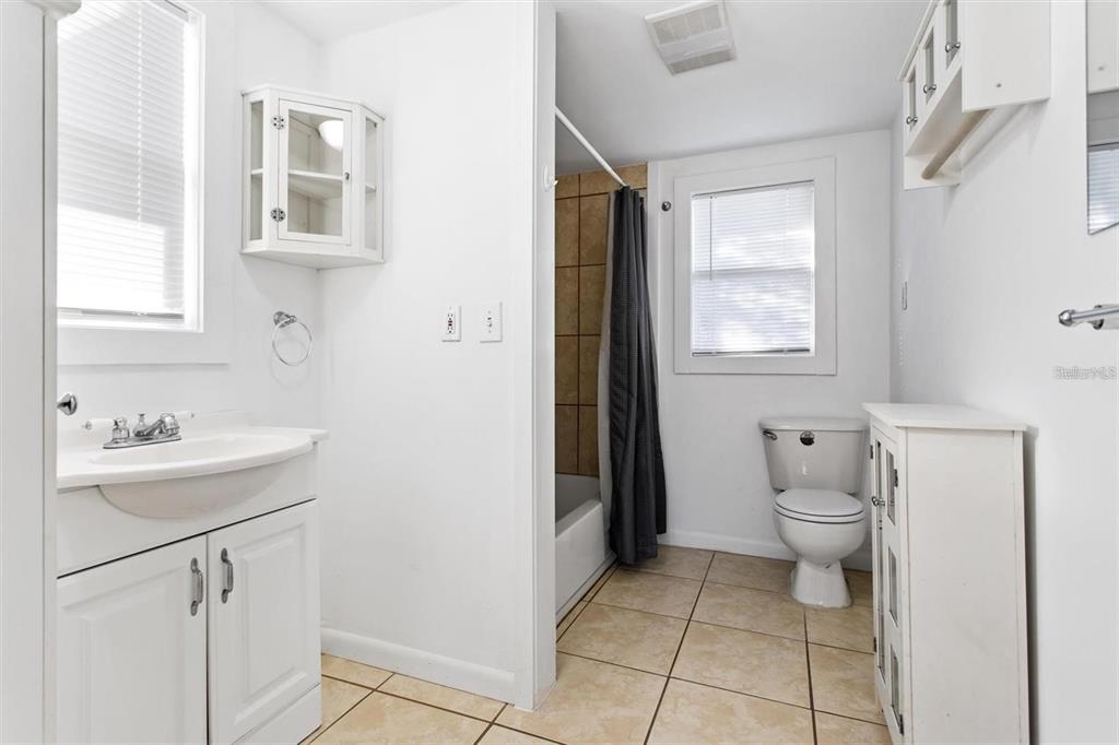 904 Lakeview Road, Unit B Clearwater, FL 33756 - Photo 11 of 19 a bathroom with a sink a toilet and a window