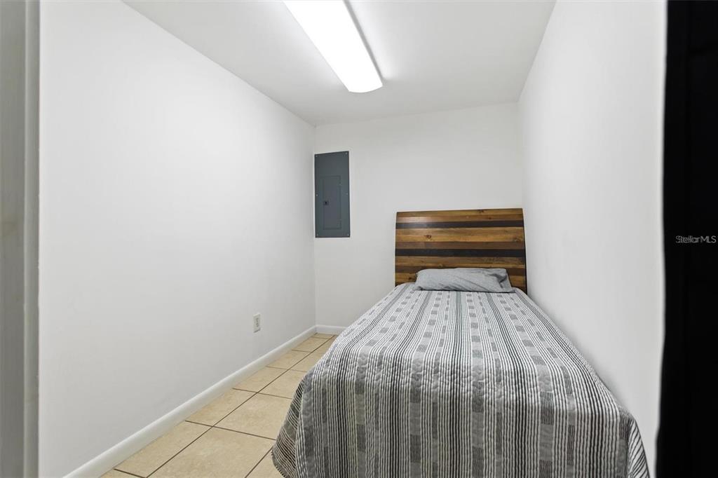 904 Lakeview Road, Unit B Clearwater, FL 33756 - Photo 12 of 19 a bed sitting in a bedroom next to a window
