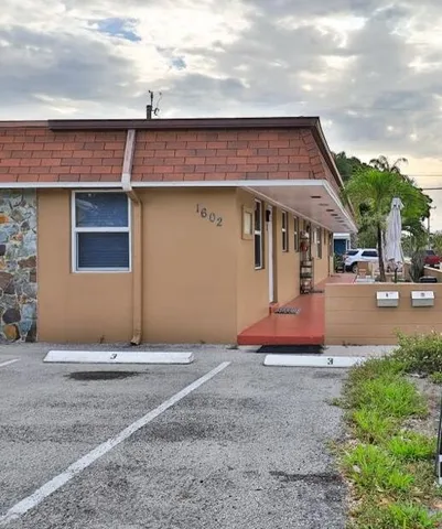 a view of a house with basketball court