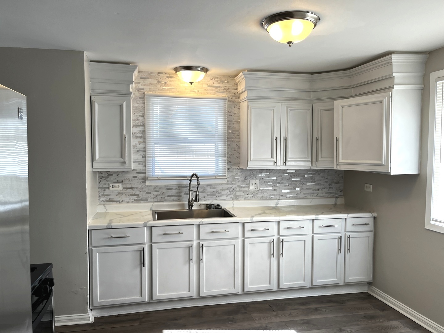 22 Apple Lane Park Forest, IL 60466 - Photo 4 of 13 a kitchen with stainless steel appliances granite countertop a sink and a stove next to a window