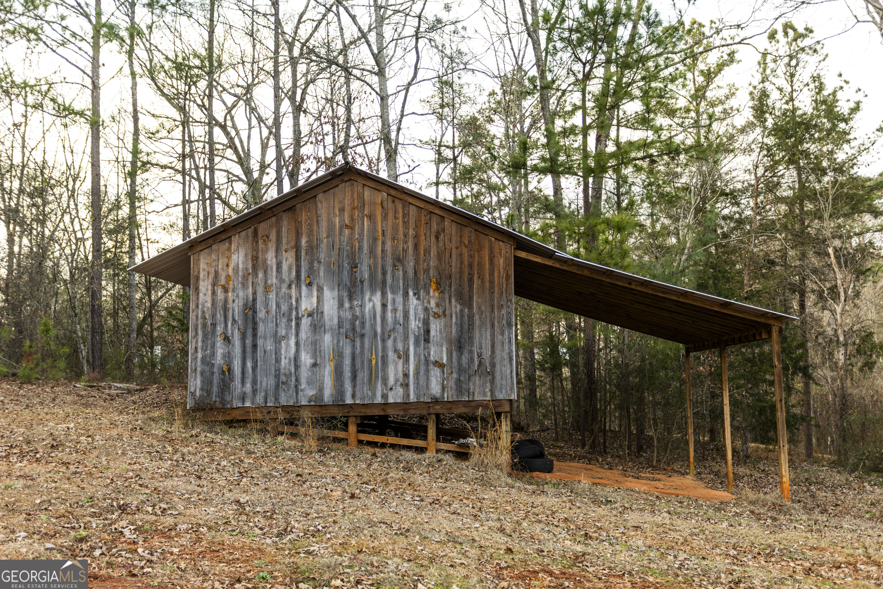 931 Bethany Road Covington, GA 30016 - Photo 16 of 83 a backyard of a house with large trees and wooden fence