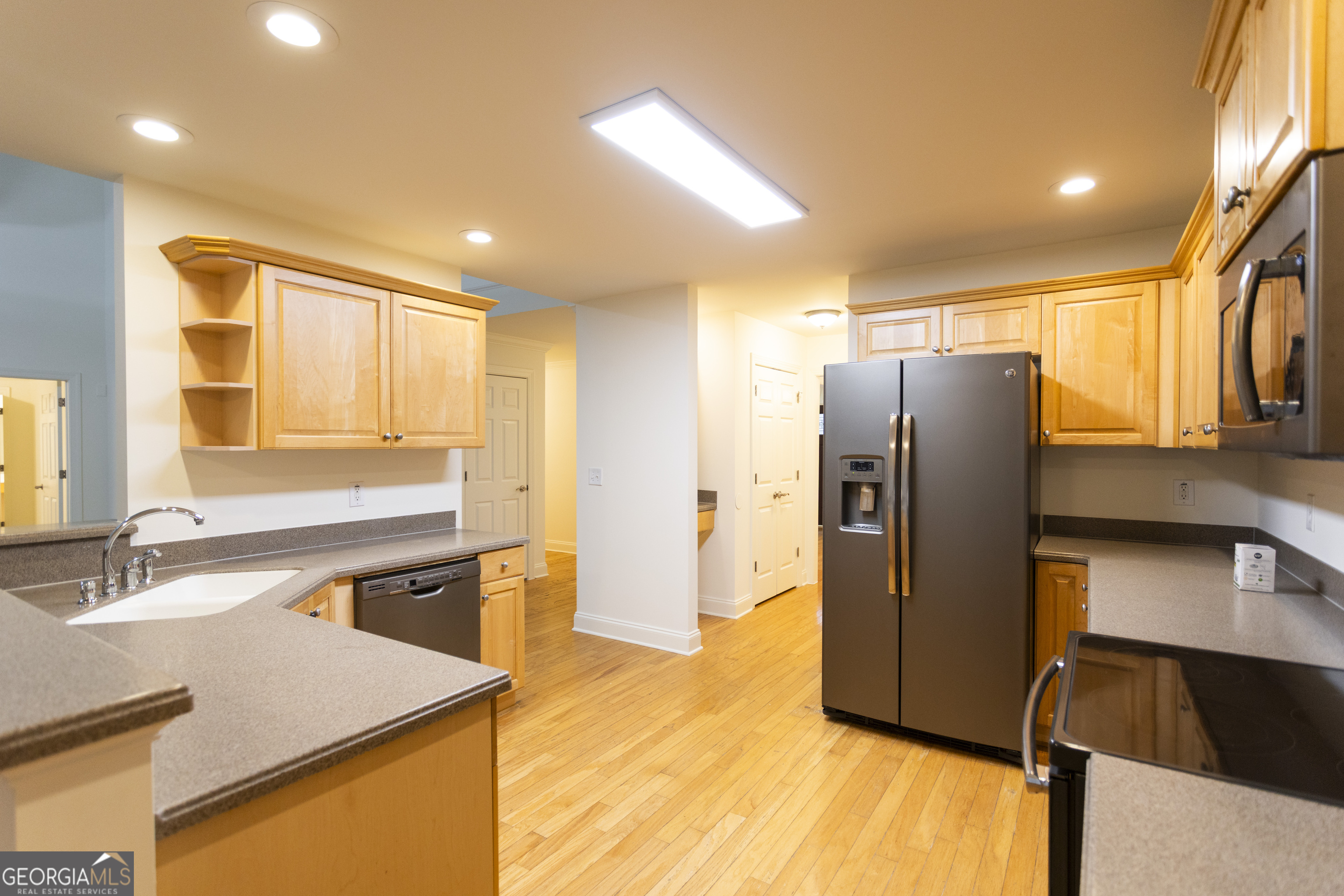 931 Bethany Road Covington, GA 30016 - Photo 33 of 83 a kitchen with stainless steel appliances granite countertop a refrigerator a sink and a stove