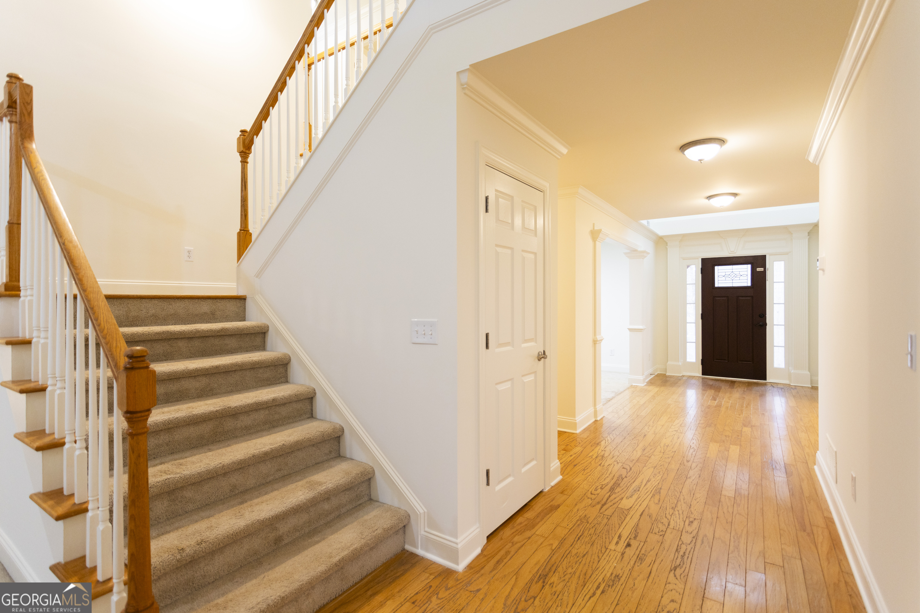 931 Bethany Road Covington, GA 30016 - Photo 48 of 83 a view of a hallway with wooden floor and staircase