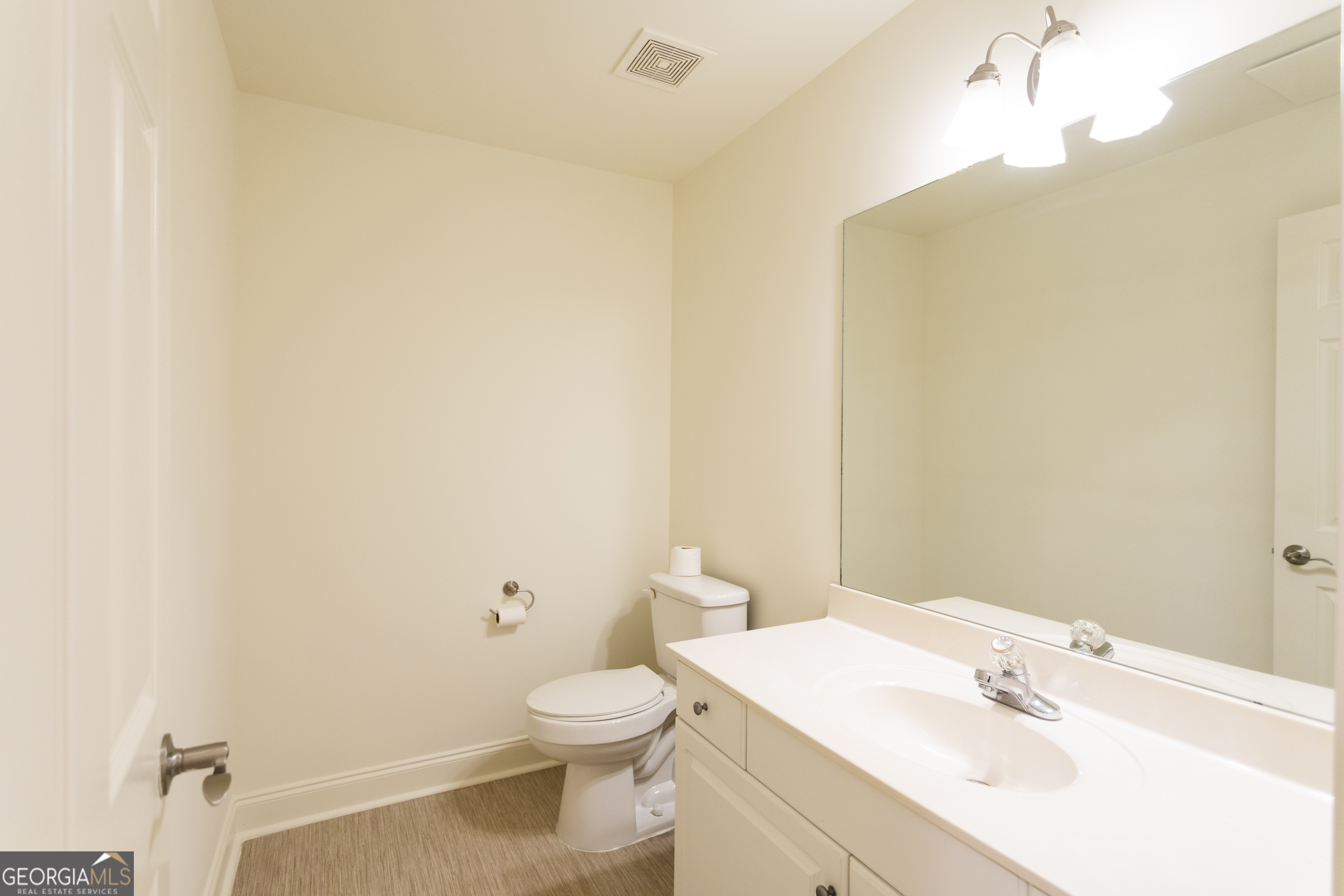 931 Bethany Road Covington, GA 30016 - Photo 49 of 83 a bathroom with a sink a toilet and vanity